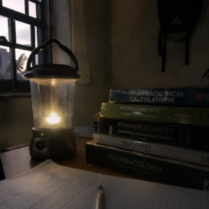 Rechargeable lantern on hostel reading table during NEPA blackout