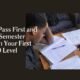 Nigerian university student studying with handouts and a notebook